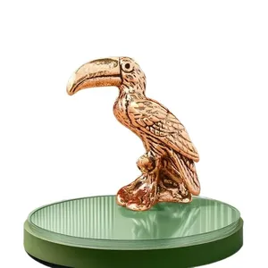 Detailed close-up of a vintage brass toucan figurine with fine feather textures
