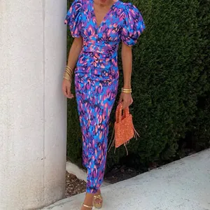 Detail of colorful leopard print fabric and ruched waist design on a V-neck midi dress