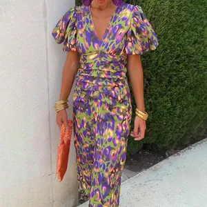 Detail of colorful floral leopard print dress with V-neck and ruched waist design