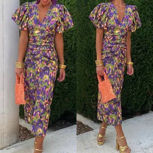 Detail view of V-neck floral leopard print dress with ruching and puff sleeves