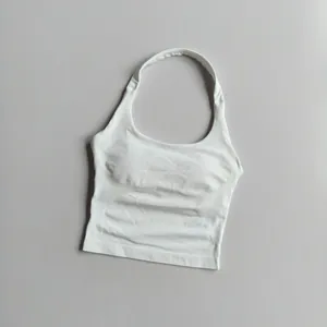 Detail of white square neck sports bra with ribbed side panels and removable pads