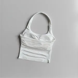Detail view of white square neck halter yoga top with ruching and ribbed texture