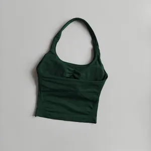 Detail showing high-elastic dark green ribbed fabric with pleated halter neckline