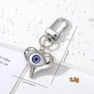 Detail view of Evil Eye heart keychain with size dimensions of 6cm height and 2.6cm width