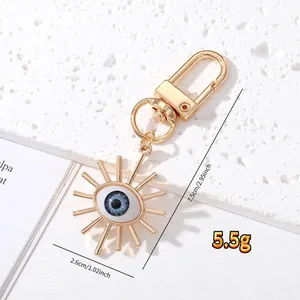 Detailed view of evil eye keychain with dimensions 7.5cm by 2.6cm and 5.5g weight