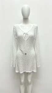 Close-up of white crochet knit hollow-out texture and V-neck drawstring with metal tips