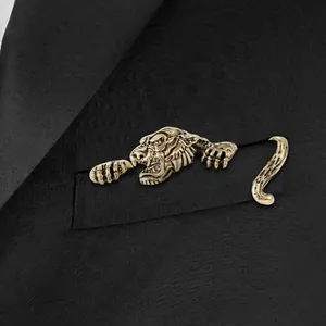 Vintage gold tiger brooch in three parts pinned to a black suit jacket pocket