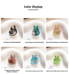Detailed view of six colorful acetate bunny hair clips with marble and glitter textures