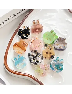 Close-up of 11-piece mini acetate rabbit and cat hair clips in various marble patterns