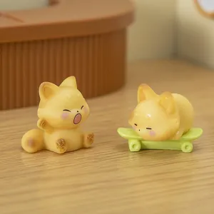 Miniature yellow fox figurines in yawning and skating poses for desk decor