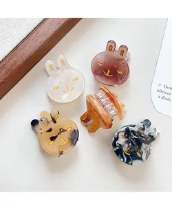 Detailed macro view of assorted colorful rabbit-shaped acetate hair claw clips