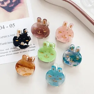 Set of 7 colorful mini acetate bunny hair clips in various patterns and pastel shades