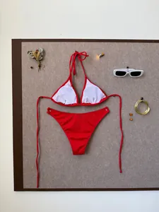 Detailed flat lay of red ribbed bikini with gold bracelets and stylish accessories