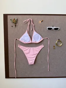Detail view of pink ribbed bikini set with soft texture and stylish summer accessories