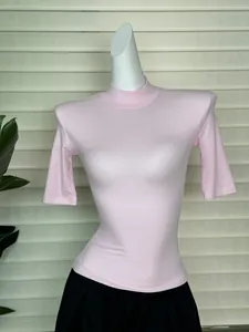 Detail of light pink high neck slim fit T-shirt with padded shoulders texture
