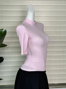 Detail view of pink mock neck slim fit T-shirt showing fine fabric texture on mannequin