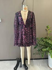 Detail view of V-neck floral print dress with long sleeves and ruffled hem design
