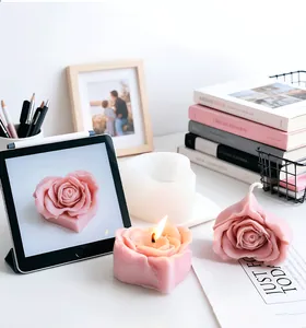 Detail of a 3D rose heart shaped candle with the white silicone mold on a cozy desk