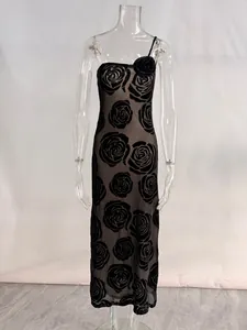 Macro detail of the 3D rose ornament and floral burnout pattern on black dress