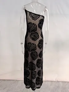 Detailed macro view of black rose velvet flocking on sheer mesh long dress