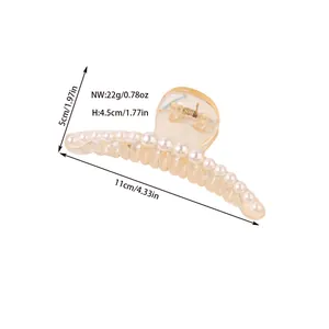 Macro shot showing dimensions and weight of the large pearl hair claw clip