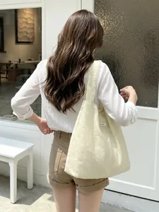 Minimalist beige tote bag with floral embroidery and wide shoulder strap for women
