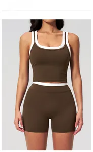 Detail of high-waist dark brown yoga set with white contrast trim and ribbed fabric