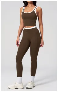 Detail of high-waisted yoga leggings and sports bra set with contrast piping
