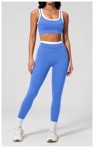 Detail of blue high-waist yoga pants and sports bra set with white contrast trim details