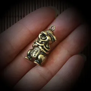 Close-up of vintage brass pig figurine with wealth character for desk or bonsai decor