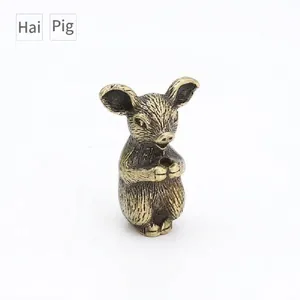 Detailed macro view of vintage brass zodiac pig figurine with brushed metal texture