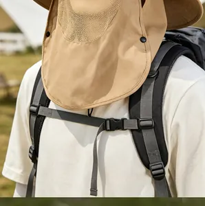 Detail of khaki outdoor sun hat with neck flap and grey backpack on hiking trail