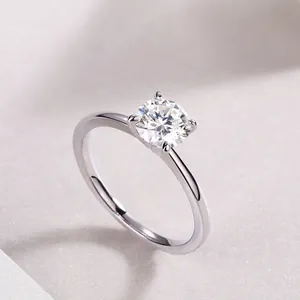 Classic 925 sterling silver four-prong moissanite engagement ring on soft fabric