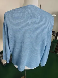 Detailed back view of a light blue hollow-out knit sweater showing breathable texture