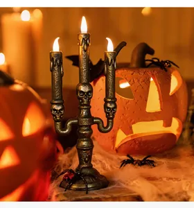 Three-headed skeleton candle holder with bronze finish and LED flame for Halloween decor