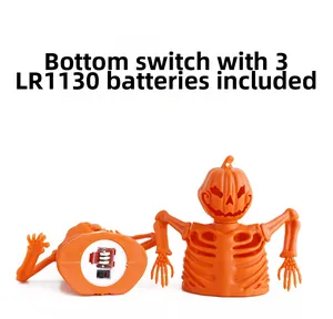 Detail view of the Halloween pumpkin skeleton base with power switch and battery cover