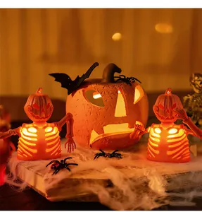Close-up of glowing Halloween pumpkin lantern set with skeleton bone lamp detail