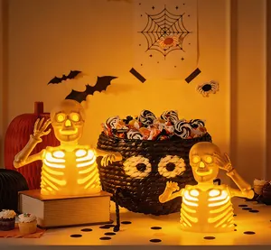 Detail of glowing Halloween skeleton bust LED lights with warm yellow illumination