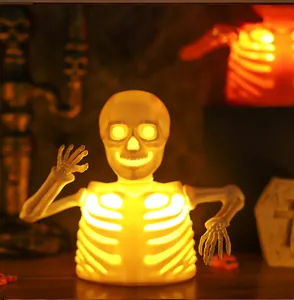 Detail of glowing Halloween skeleton bust lamp with warm LED light for spooky party decor