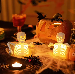 Detail of glowing Halloween skeleton LED lamps with warm orange light for party decor