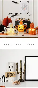 Detail of Halloween LED skeleton lights and pumpkin lanterns on a festive desktop