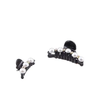 Elegant black hair claw clips set with white pearls and sparkling rhinestones