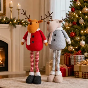 Close-up of two plush Christmas reindeer dolls with long striped legs in a festive scene