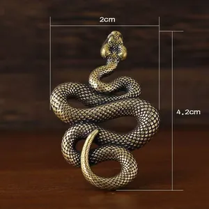 Macro detail of brass snake figurine with scale texture, 4.2cm height and 2cm width