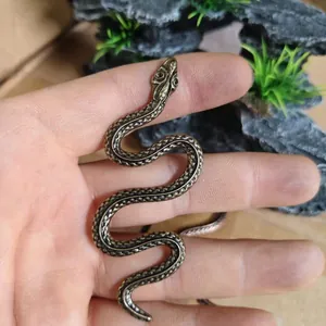 Detailed close-up of textured snake scales on a vintage solid brass cobra figurine