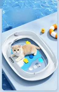 Cat lying on a large cooling water bed with blue ocean patterns and fish graphics