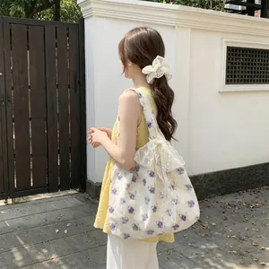 Floral canvas tote with large lace bow and matching scrunchie for outdoor styling