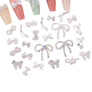 Silver bow nail art charms set with pearls and rhinestones for DIY manicure designs