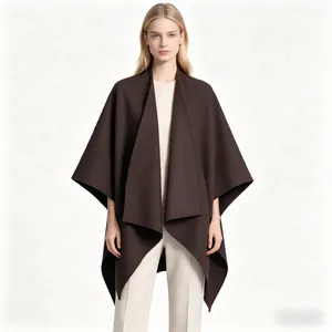 Detail of dark brown oversized poncho coat with premium thick fabric drape and V-neck style