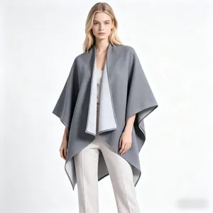 Detail shot of a thick grey shawl coat with premium double-sided wool and draped hem
